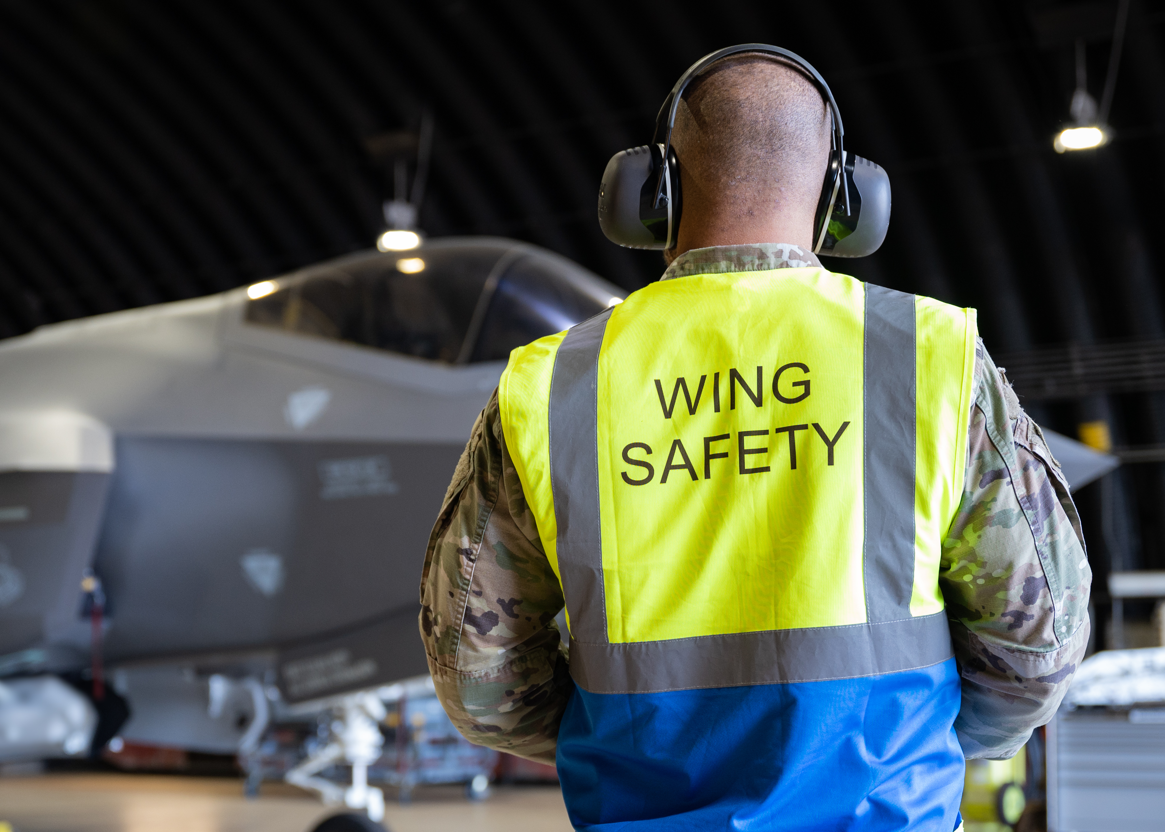 Wing Safety personnel in front of plane